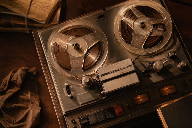 A vintage reel-to-reel tape recorder mid-session